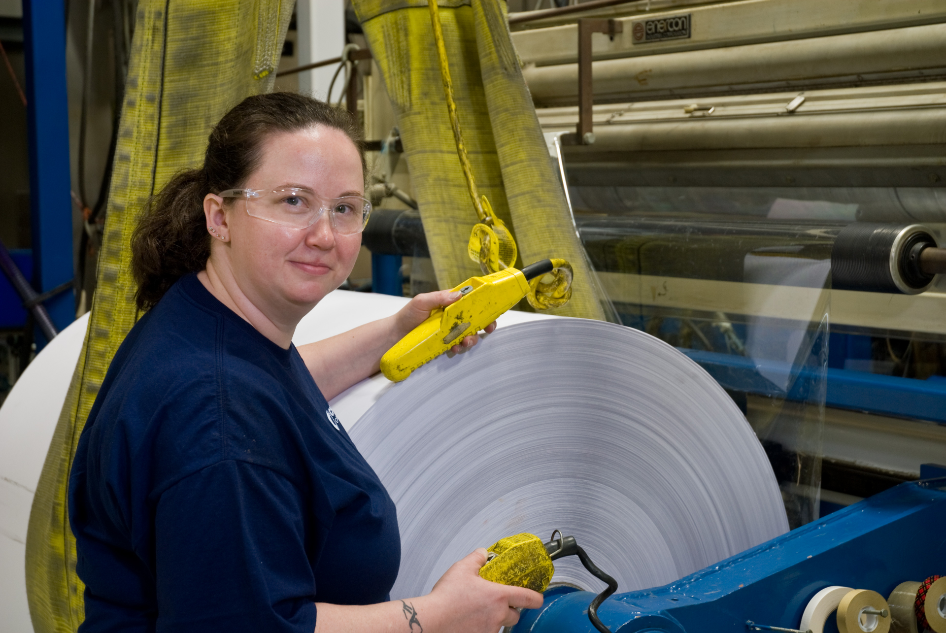 Factory technician working with a roll of p